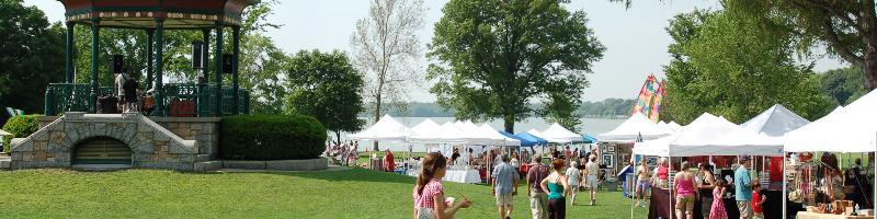 Festival tents, lake, gazebo, and crowd